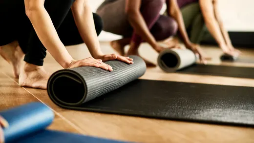 Tappetini arrotolati alla fine di una lezione di yoga